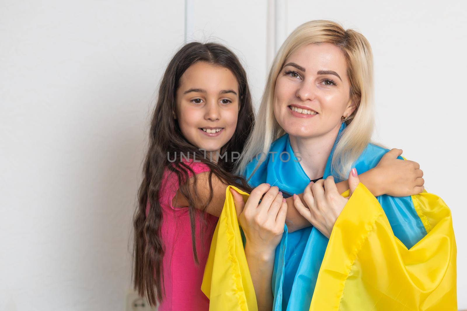 mother and daughter with ukraine flag by Andelov13