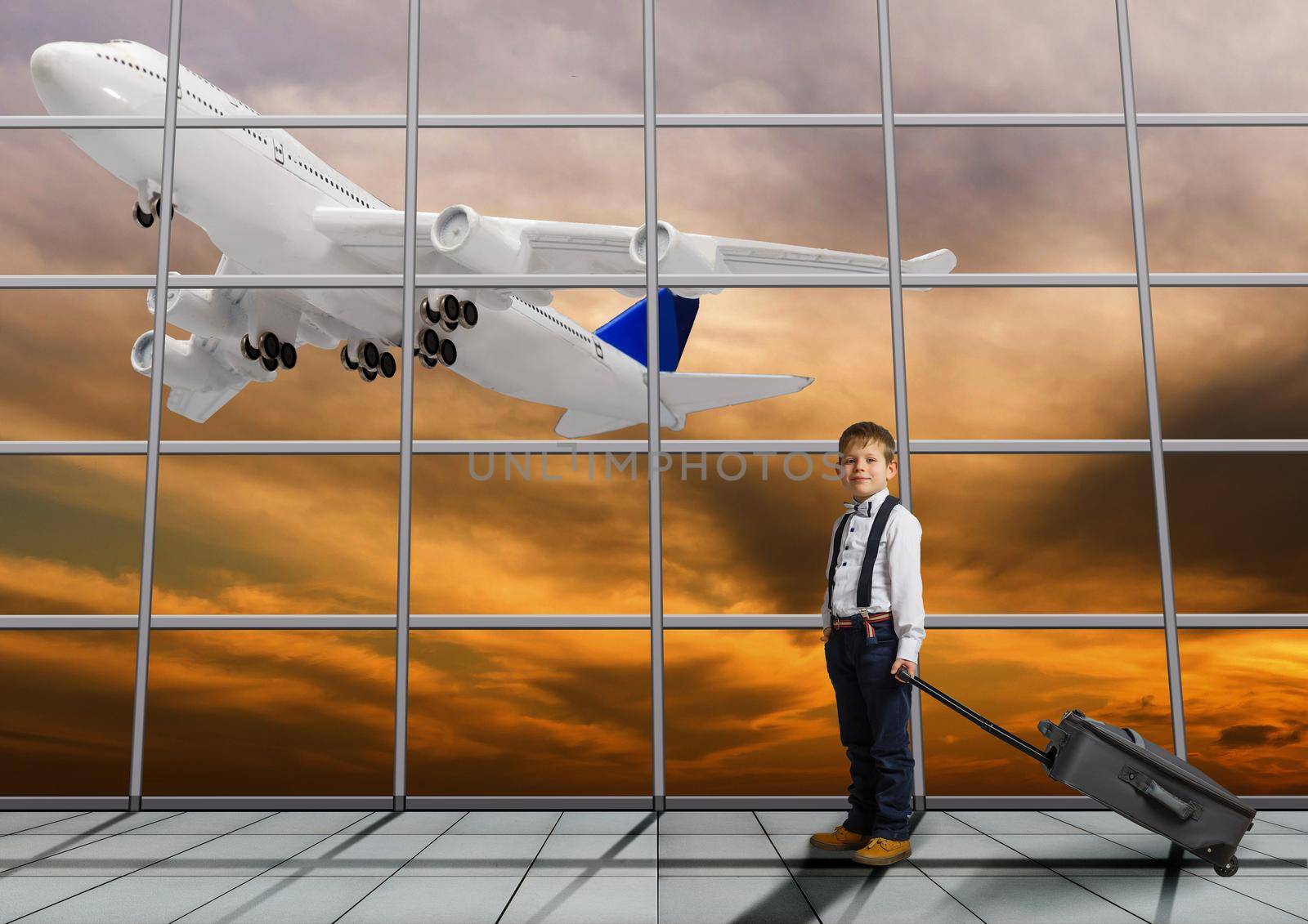 Travel tourist standing with luggage watching sunset at airport window. Unrecognizable woman looking at lounge looking at airplanes while waiting at boarding gate before departure. Travel lifestyle. High quality photo