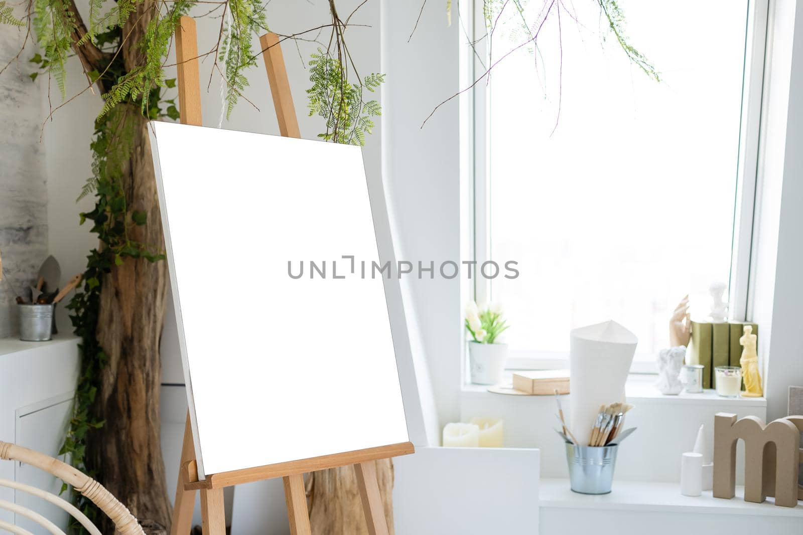 Easel with painting in artist's workshop by Andelov13