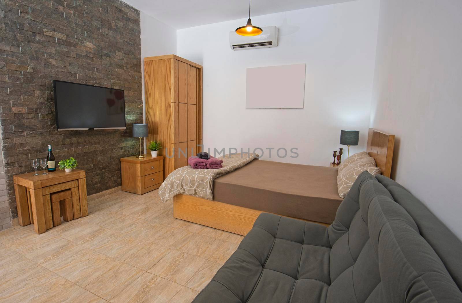 Interior design decor showing modern bedroom area in open plan luxury studio apartment showroom