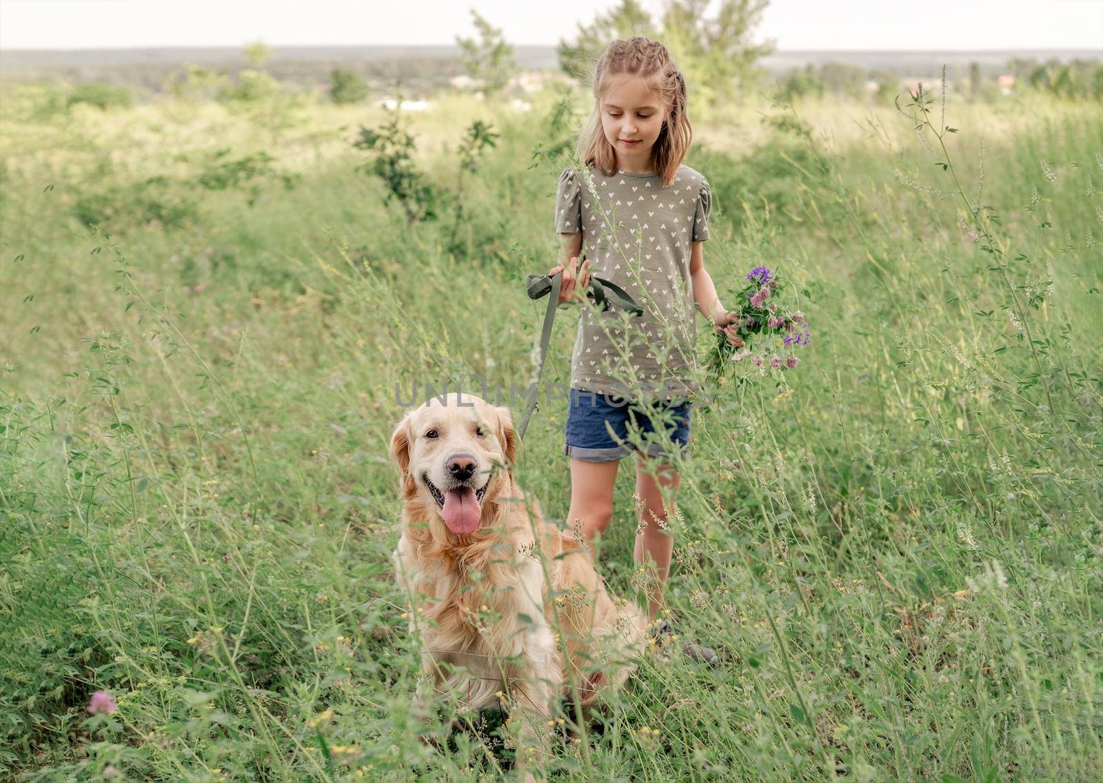 Portrait of beautiful preteen girl with golden retriever dog and flower bouquet outdoors. Cute female kid with doggy pet at the nature in summer time