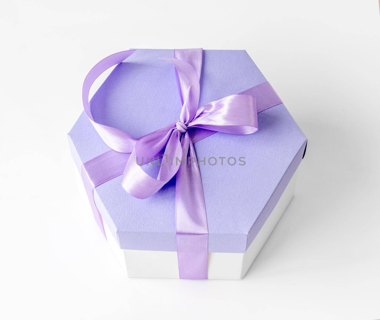 Beautiful gift box with lavander ribbon for celebration. Romantic present package from above view