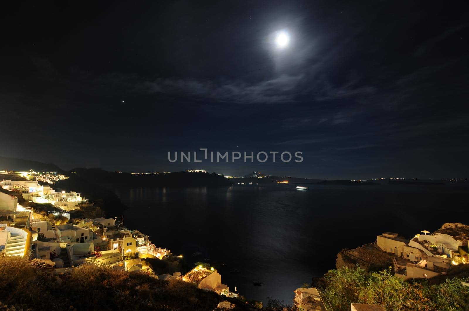 Sunset night view of traditional Greek village Oia on Santorini island in Greece. by feelmytravel