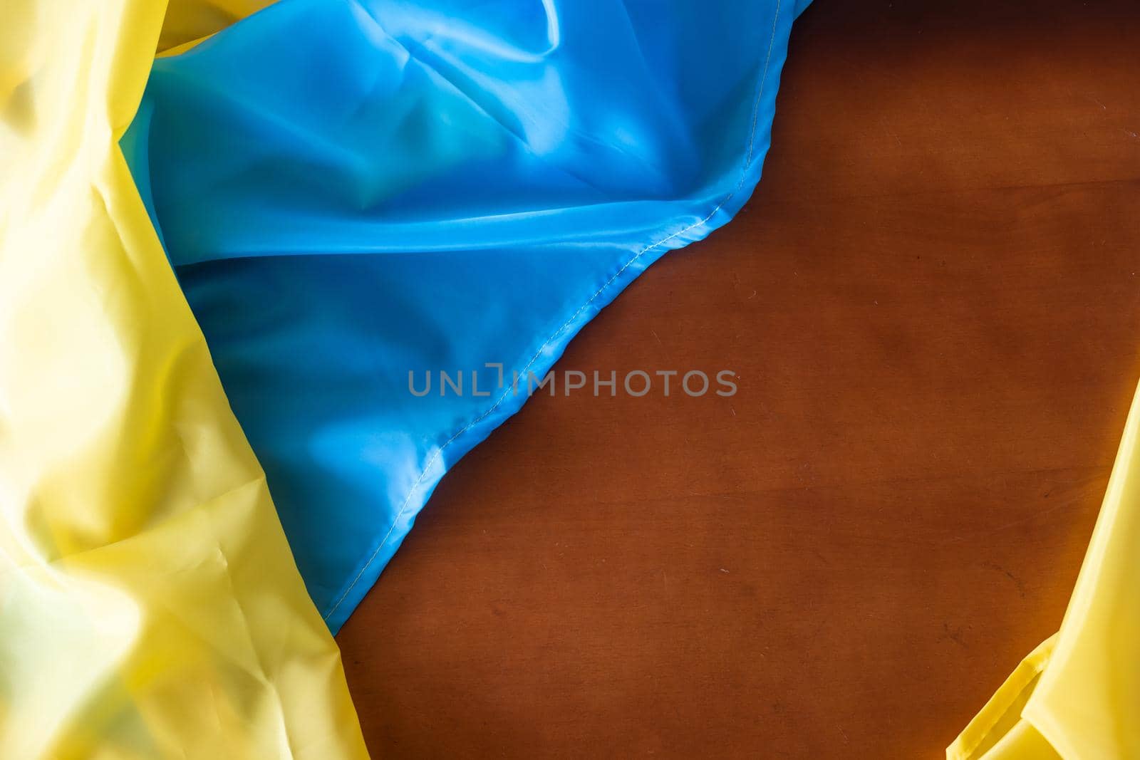 Ukraine flag on wooden table background.