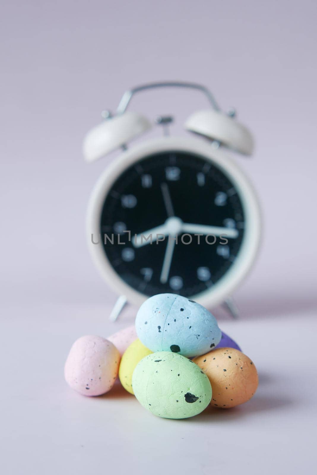 easter concept with egg and a clock on table ,