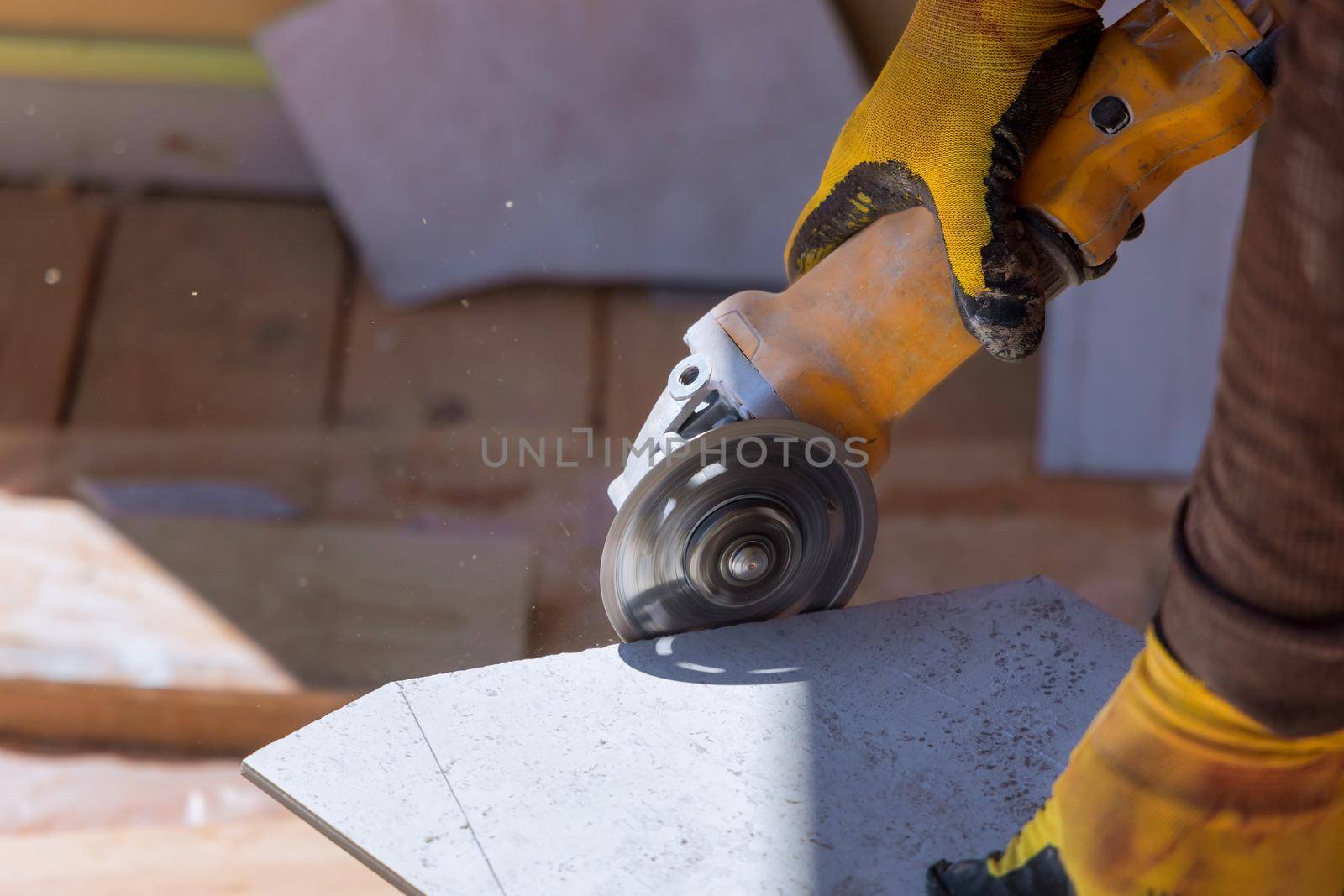 Close up of worker use cutting machine cut a ceramic tile saw