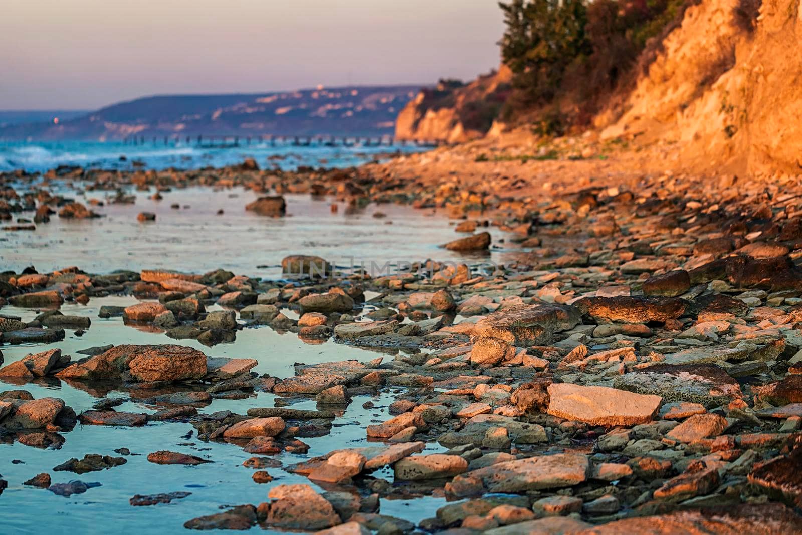 At a stone coastline at the Black sea. Relaxing horizontal view. Blurred background