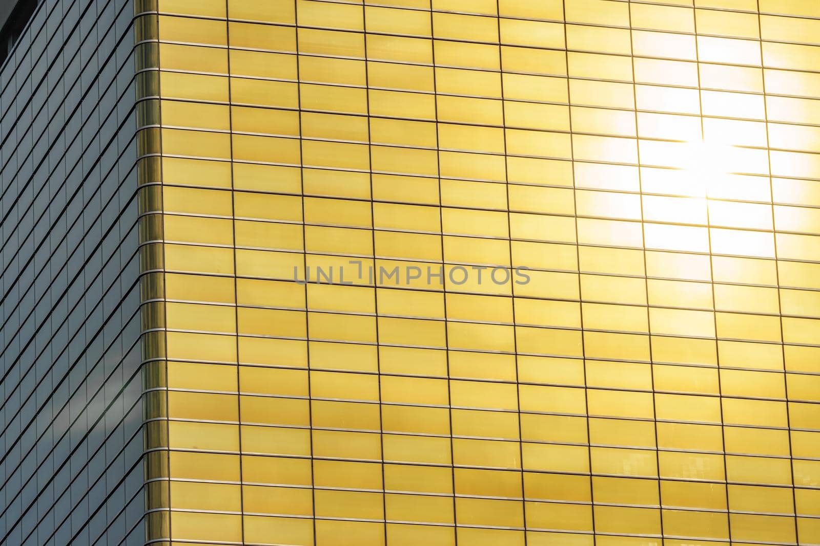 Long shot of sun reflected in golden building