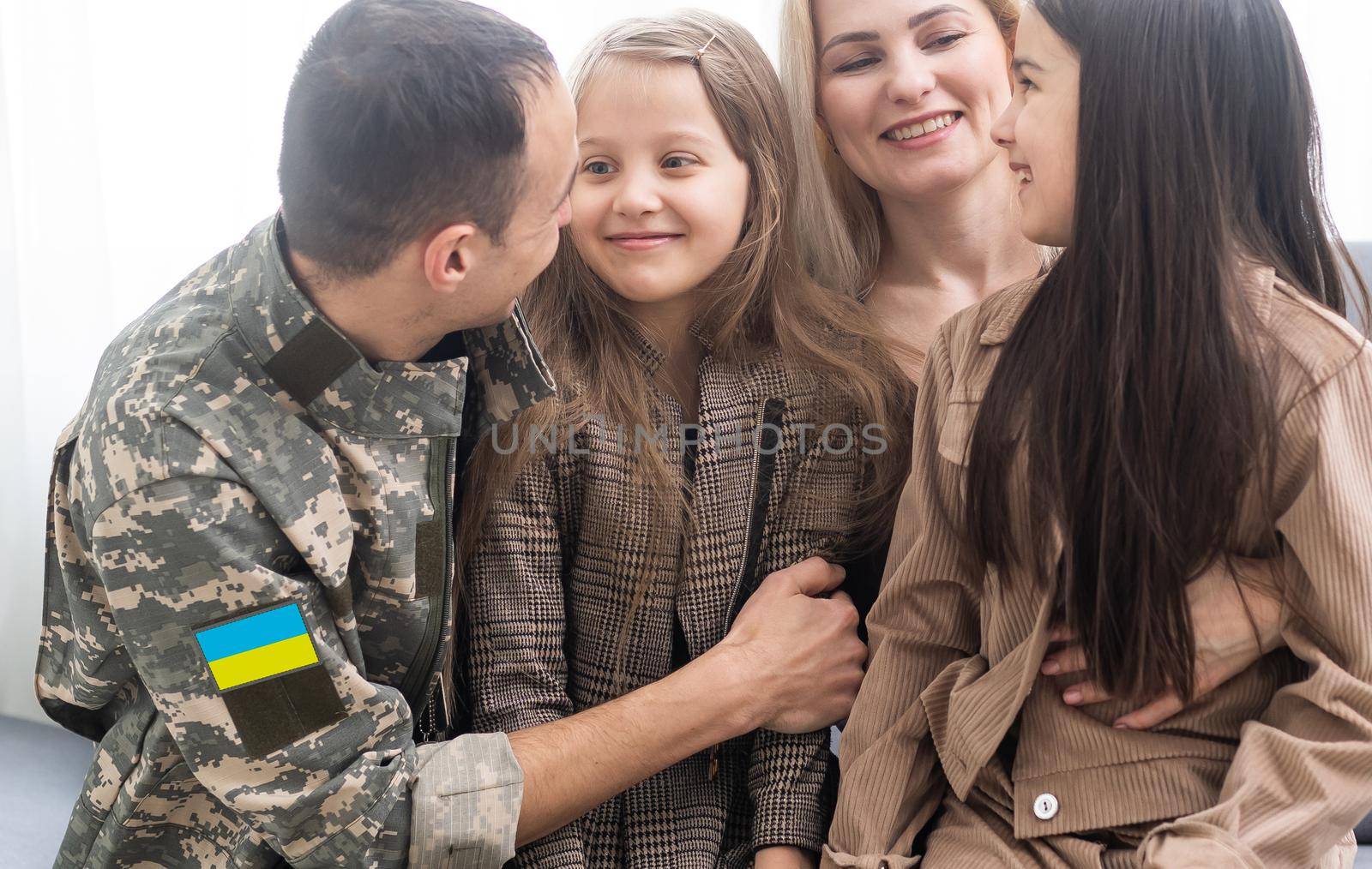 Happy Ukrainian soldier in military, cheerful daughter, Ukrainian veterans of Russian-Ukrainian, Independence Day.