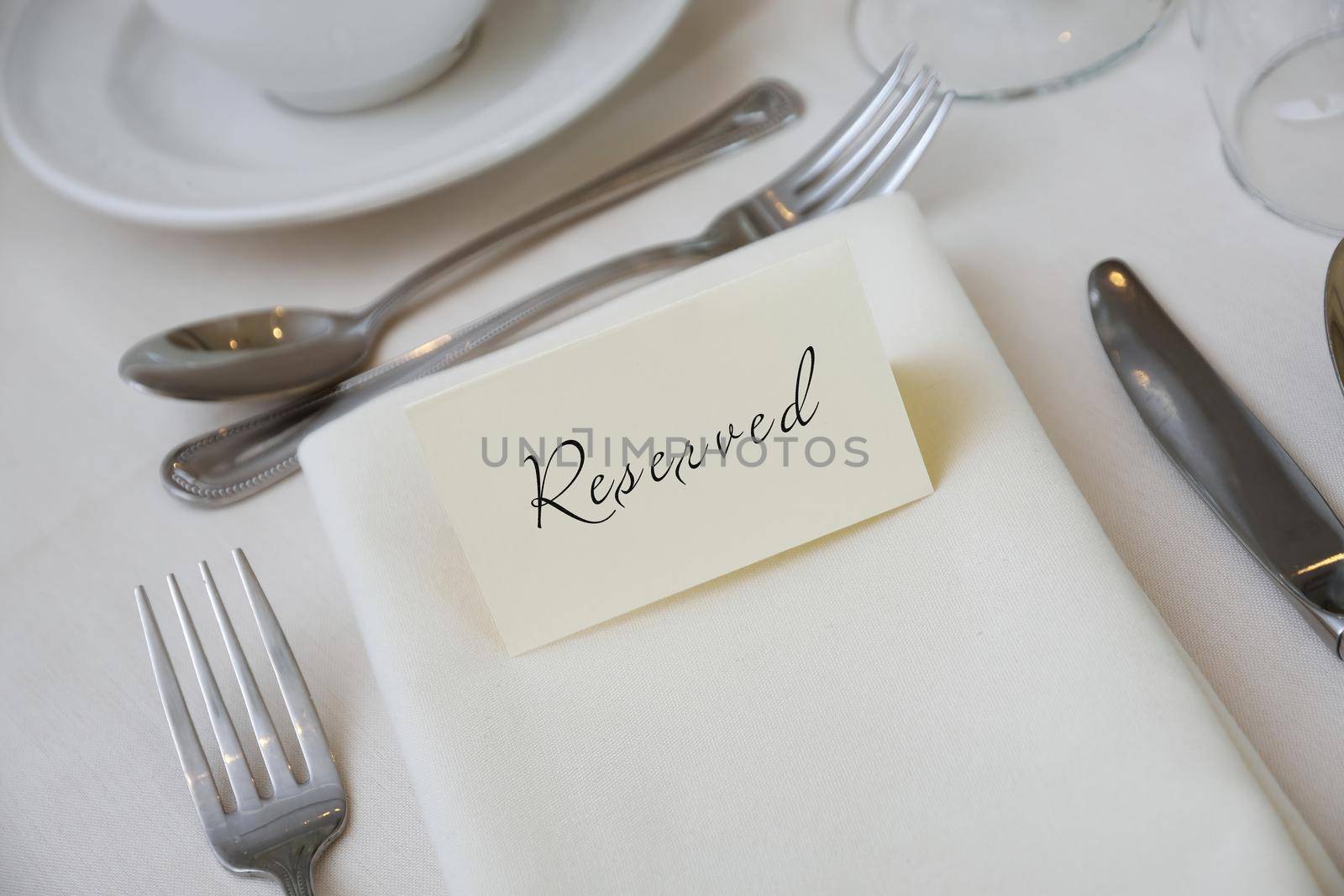 Reserved Sign at a Table Setting with White Tablecloth by markvandam