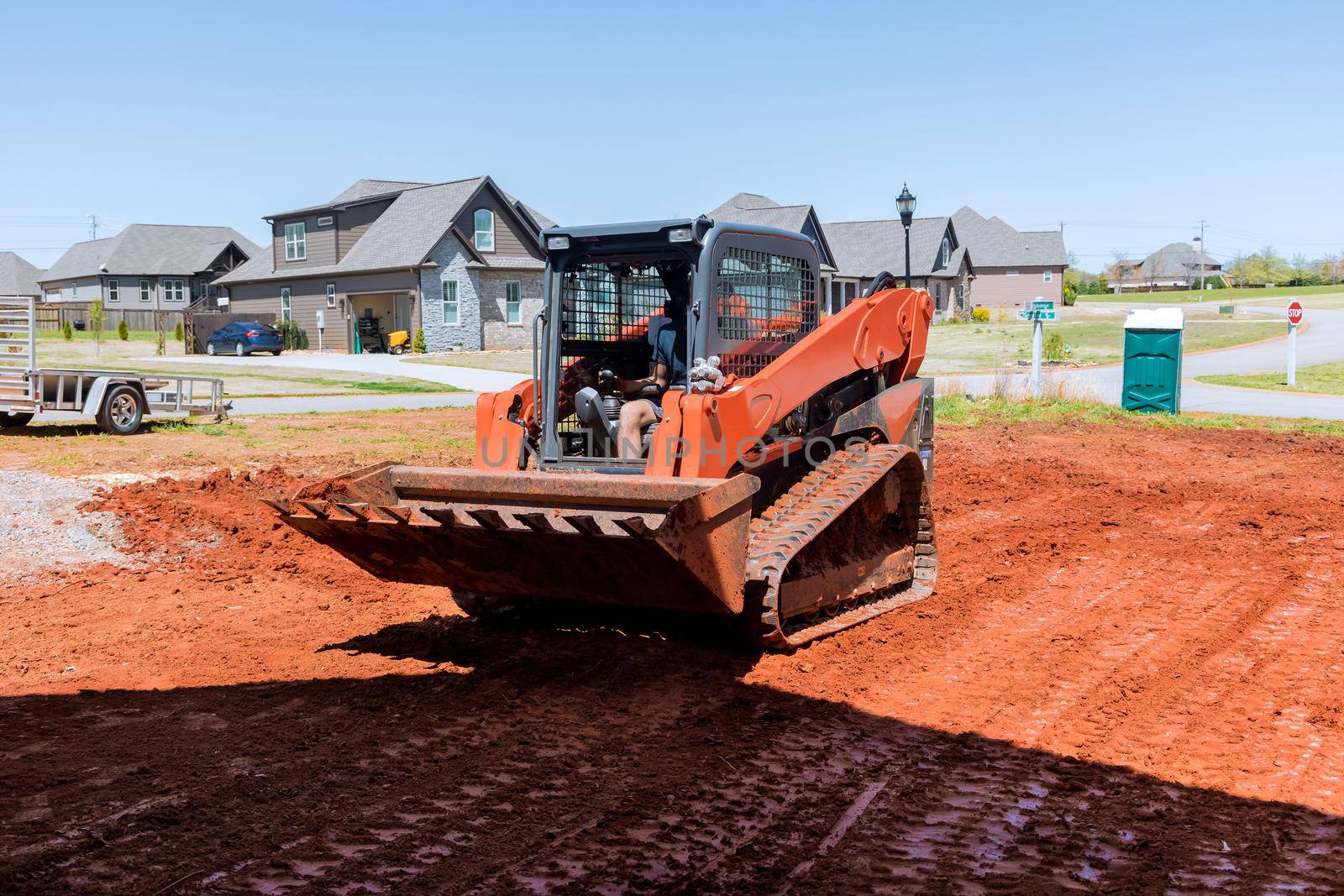 Bulldozer at work with during landscaping works by ungvar