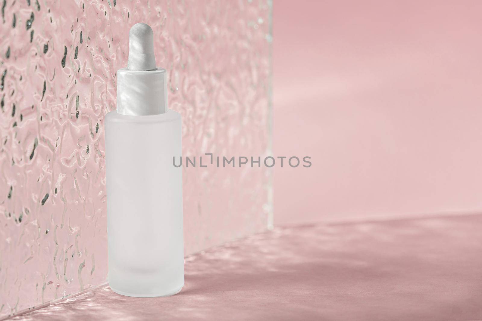 Hyaluronic acid oil, serum with collagen and peptides skin care product on background with acrylic ribbed plate. Cosmetic liquid mockup in transparent bottle. Mock up packaging by photolime