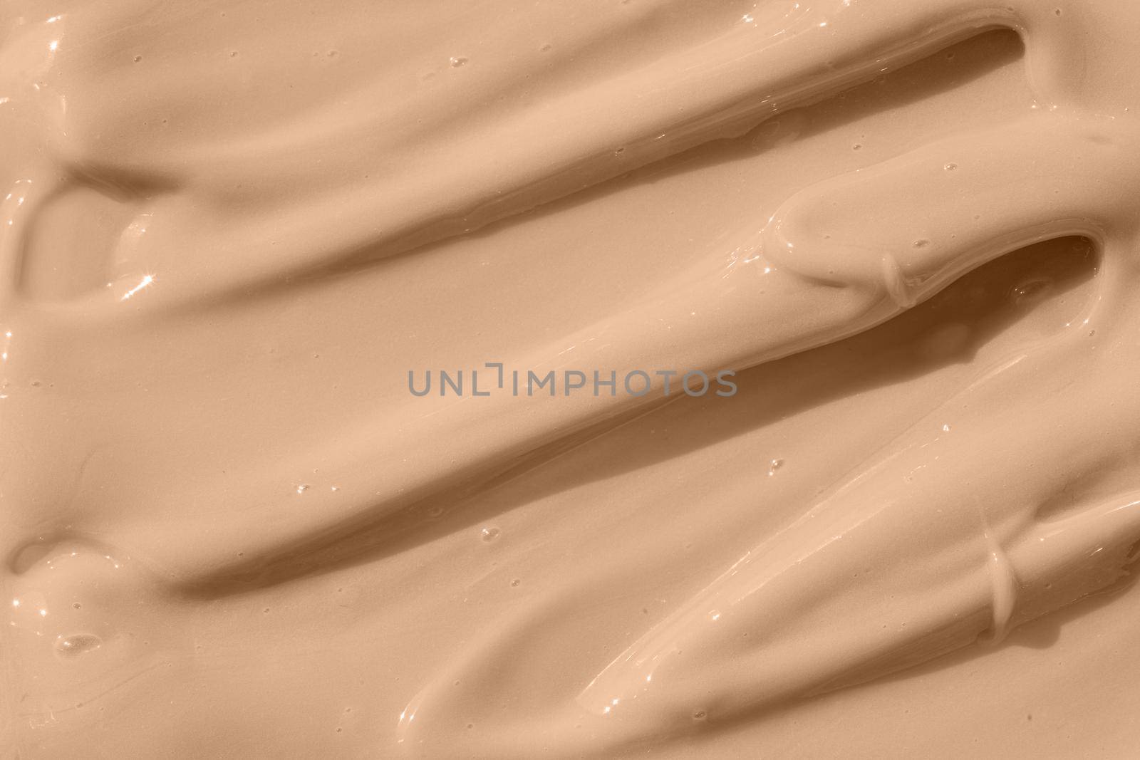 Beige nude liquid foundation texture, concealer smear smudge drop. Cosmetic tonal makeup moisturizer, bb cream swatch sample. Make up base, cream textured background. Closeup macro