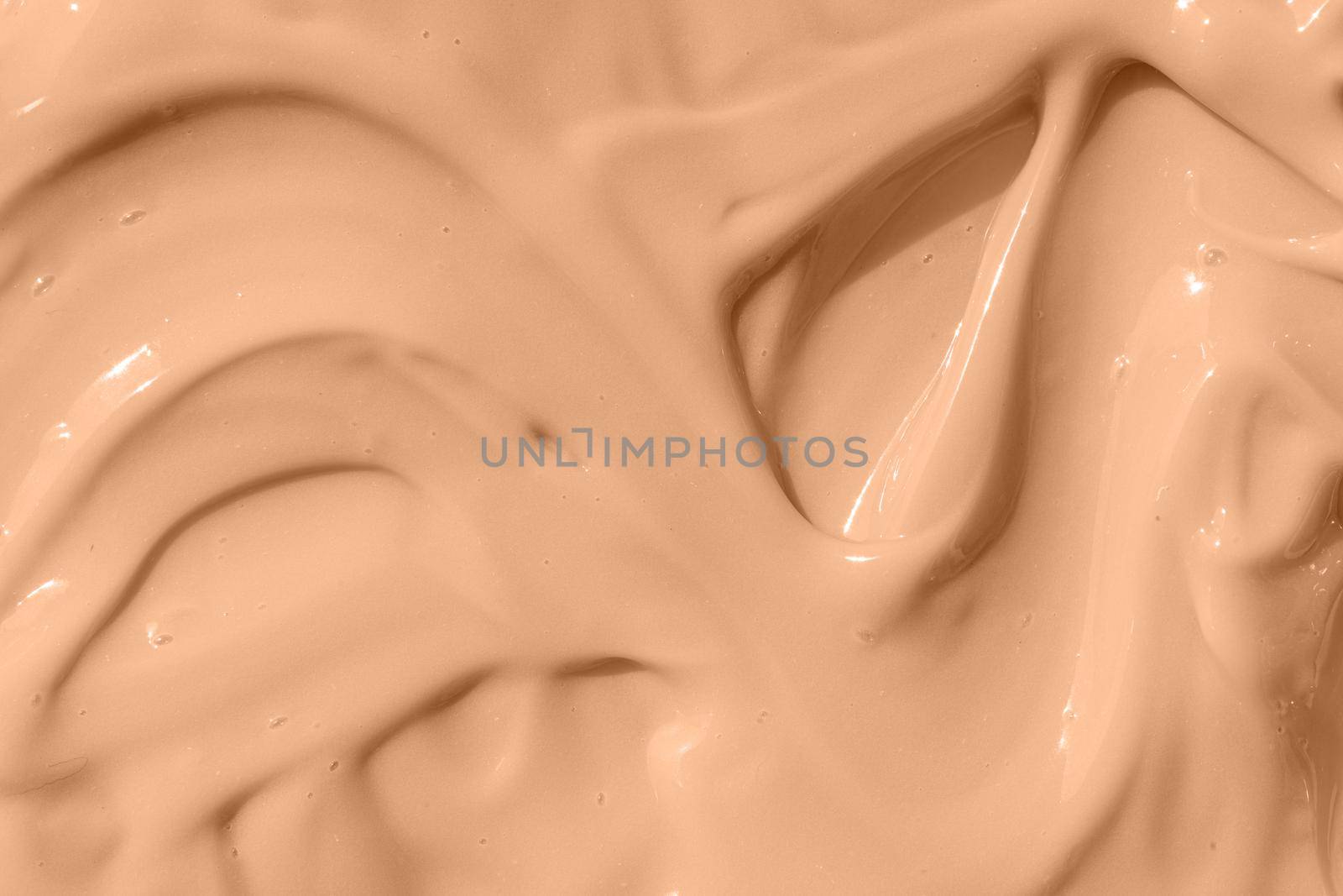 Beige nude liquid foundation smear, concealer texture smudge. Make up base drops, cream textured background. Closeup macro. Cosmetic tonal makeup moisturizer, bb cream swatch by photolime