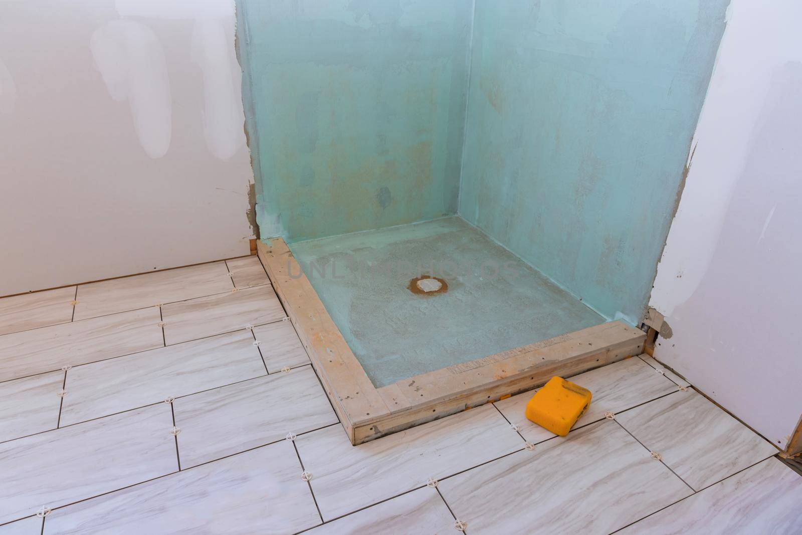 Under construction new bathtub remodeling a home bathroom with laying floor ceramic tile
