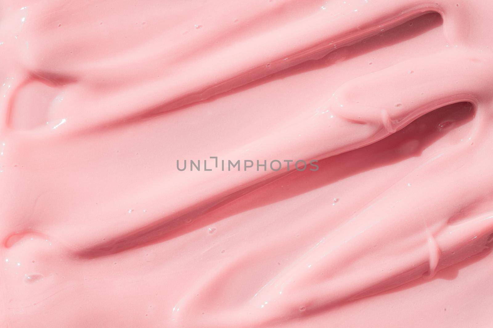 Pink color cosmetic cream lotion moisturizer smear smudge sample. Beauty cream texture background. Skin care product strokes closeup. Creamy textured backdrop