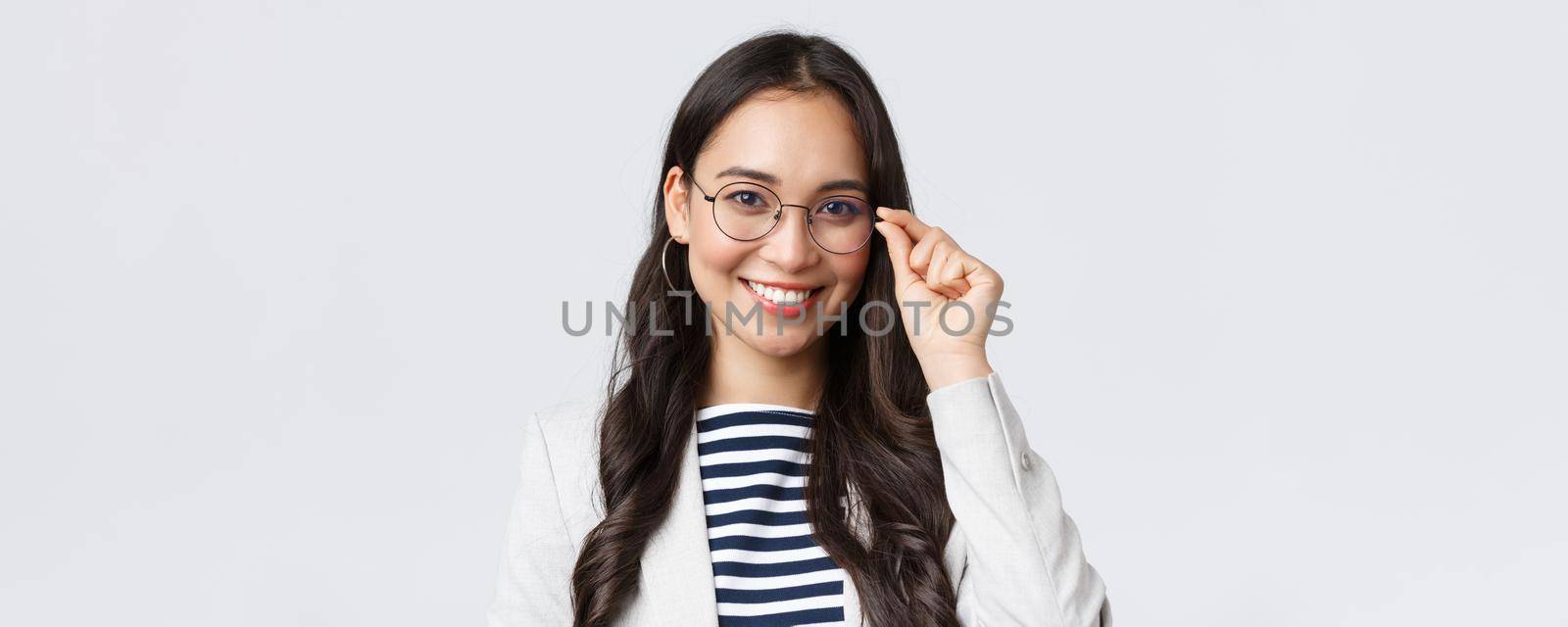 Business, finance and employment, female successful entrepreneurs concept. Talented young asian female IT programmer in glasses, customer support manager smiling at camera.