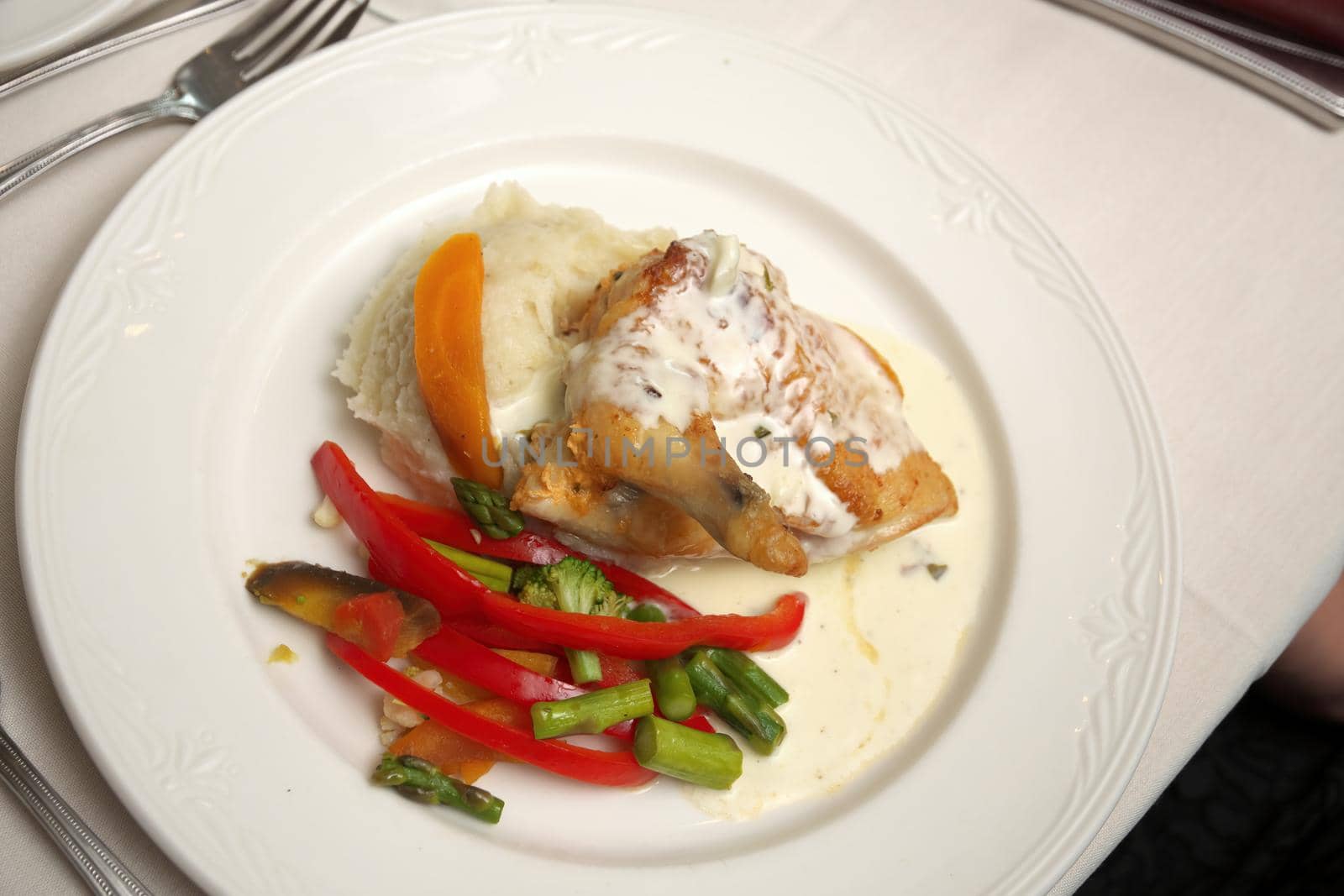 Roasted Chicken Dinner with White Cream Sauce and Sauteed Seasonal Vegetables and Mashed Potatoes. High quality photo