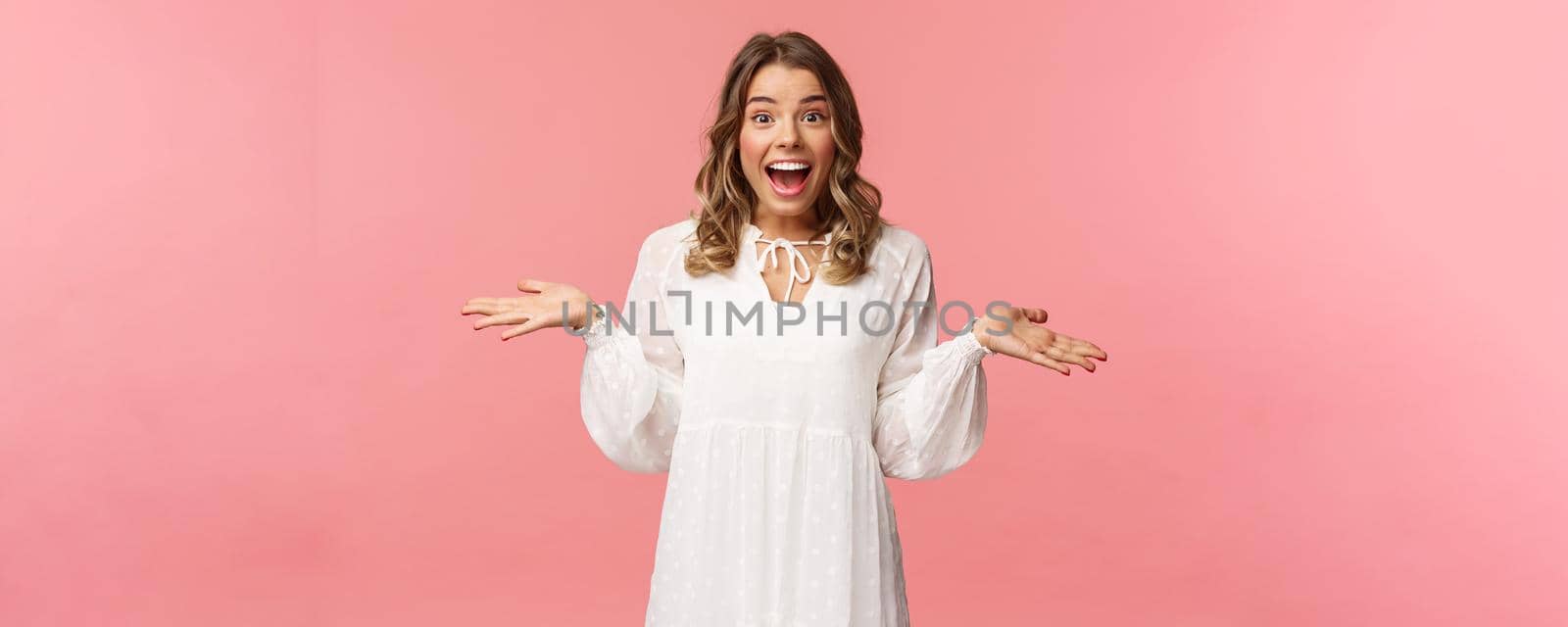 Surprised and happy young blond girl realise she won, receive really good news, spread hands sideways smiling and look amazed at camera, standing pink background lucky and upbeat by Benzoix