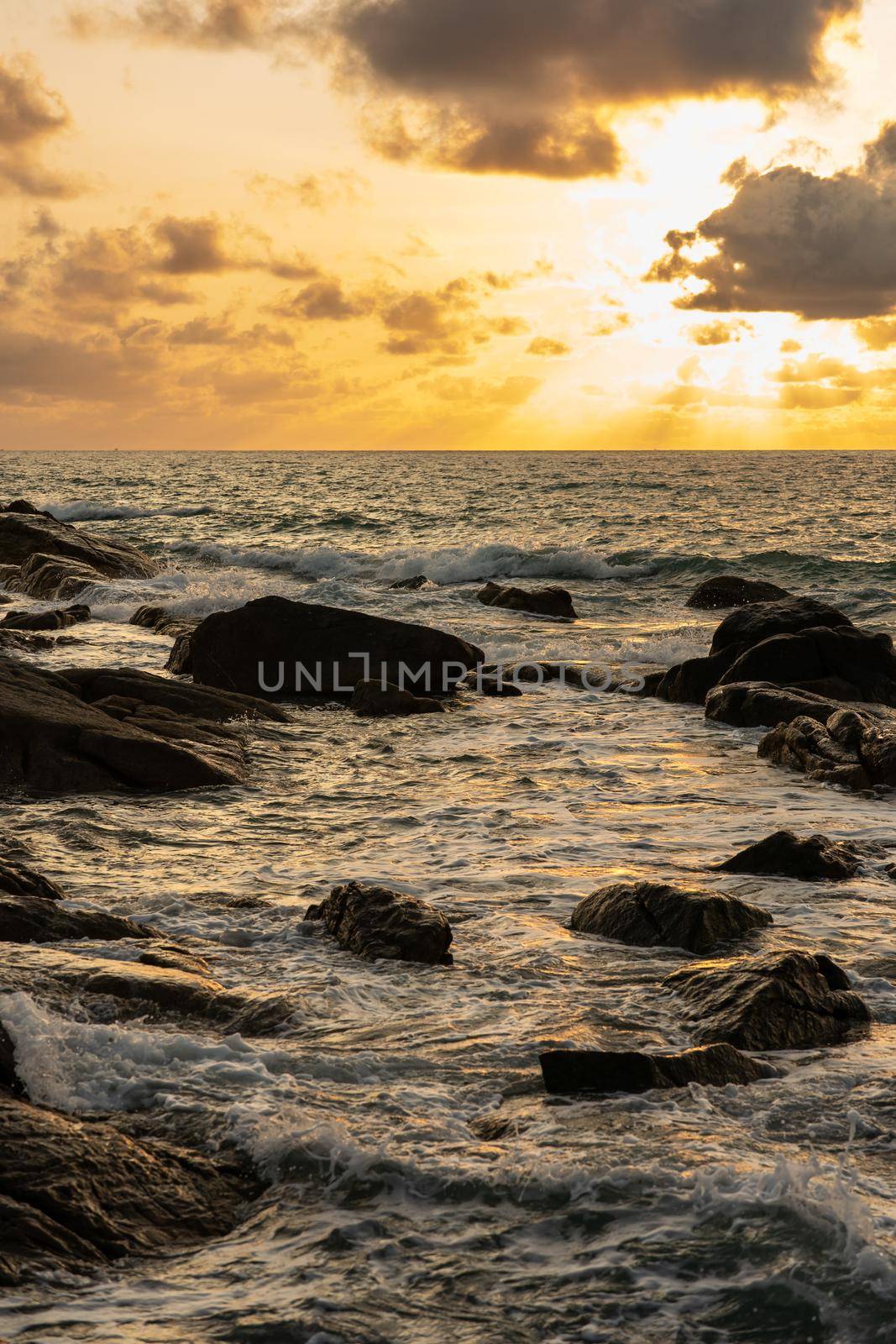 A beautiful sunset on the rocky beach. by sirawit99