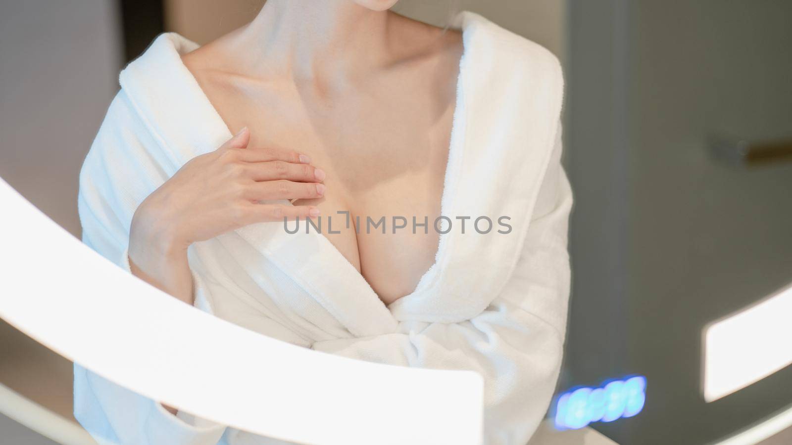 Woman in bathrobe, close up on chest. by sirawit99