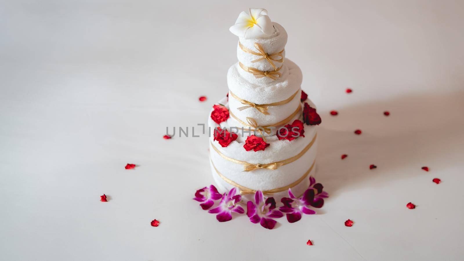 Celebrating surprise in bed with towel cake.