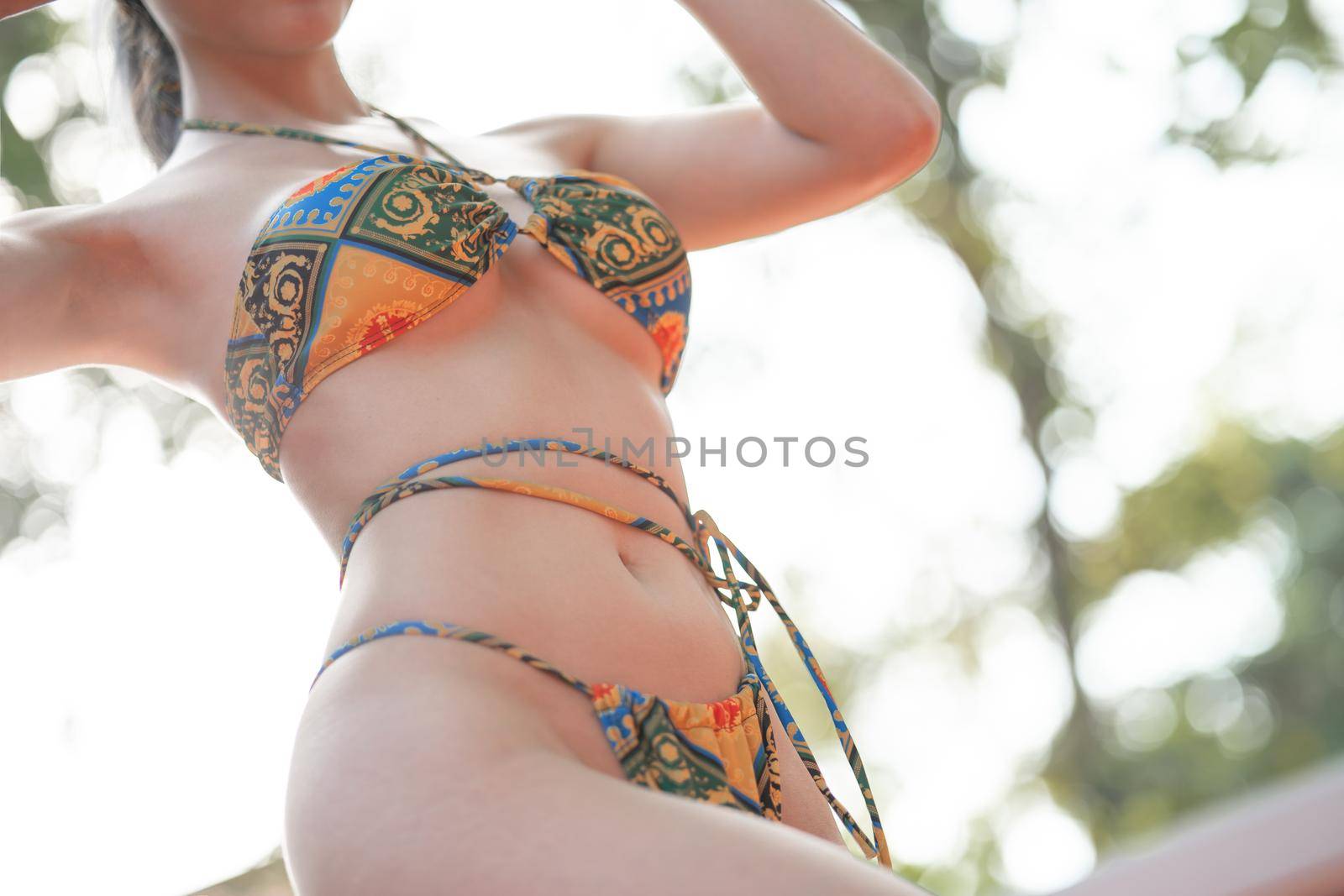 Close up of sexy woman in bikini standing in tropical villa outdoor. by sirawit99