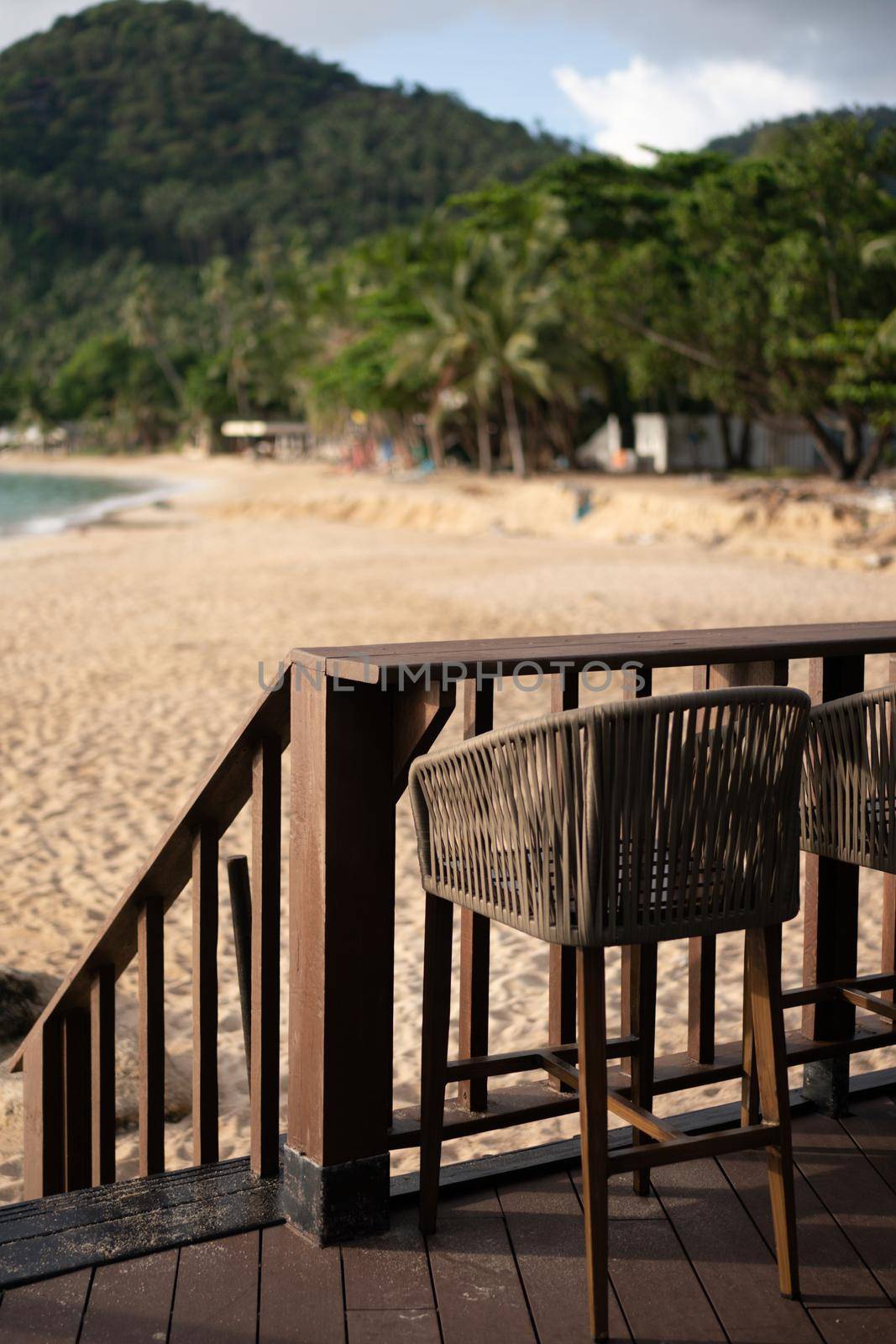 Wooden tables and beach bar, cafe next to the beach.