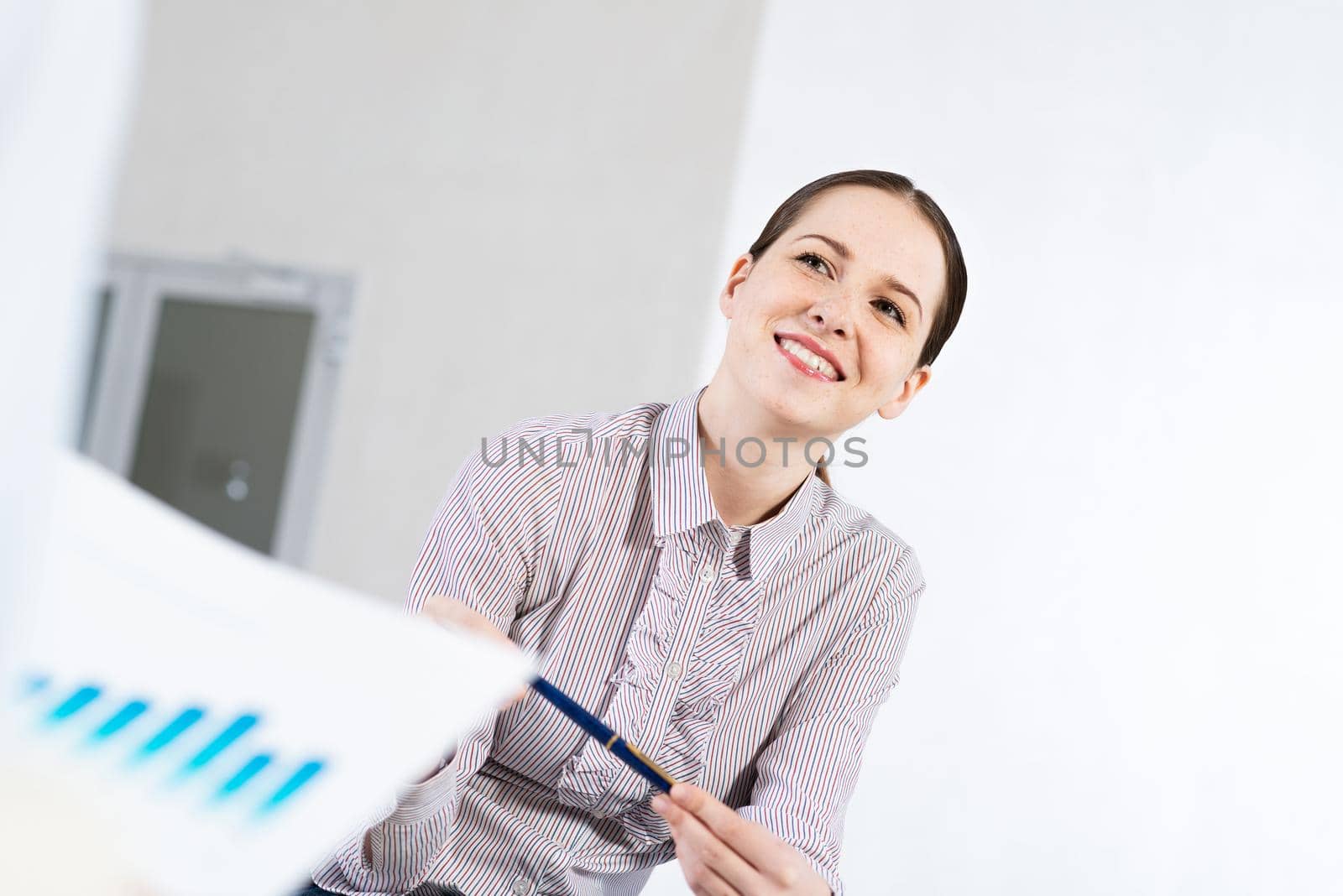 Portrait of a young attractive woman, in an office space