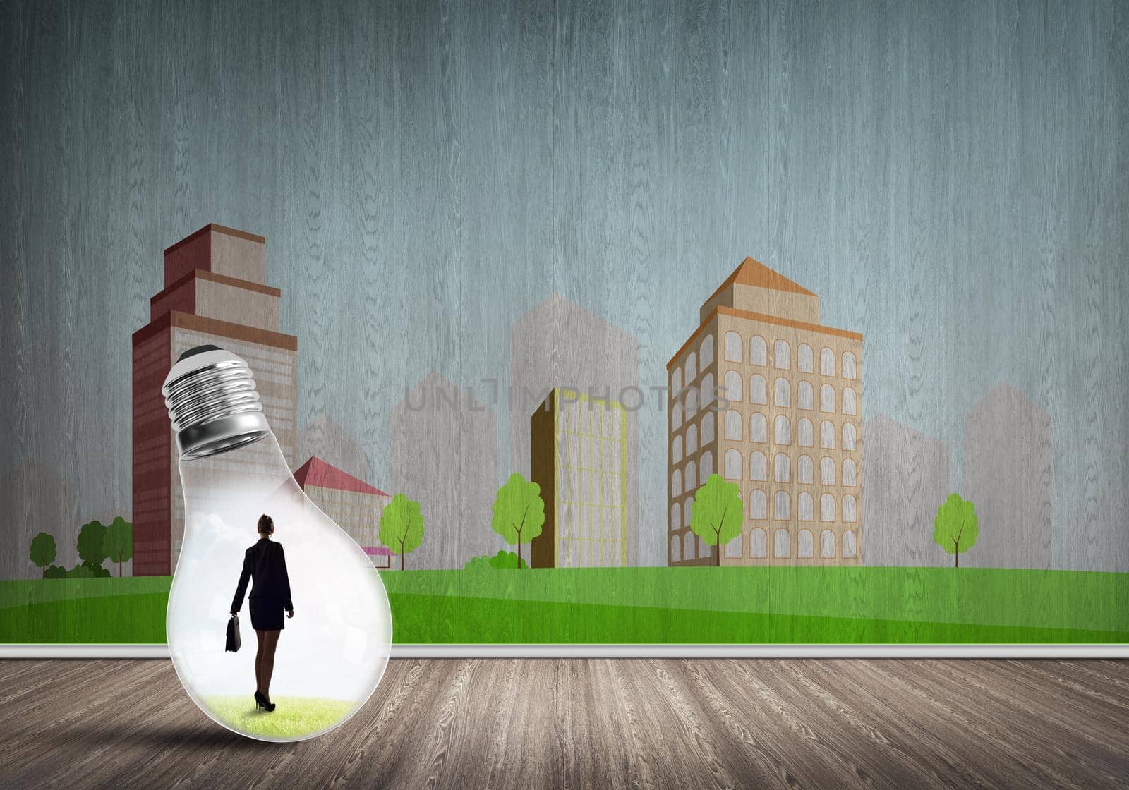 Businesswoman inside light bulb against city drawn concept