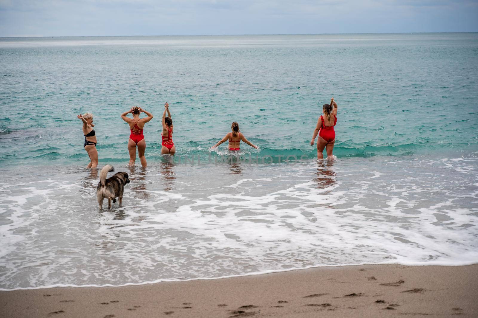 Big happy family or group of five friends is having fun against sunset beach. Beach holidays concept. by Matiunina