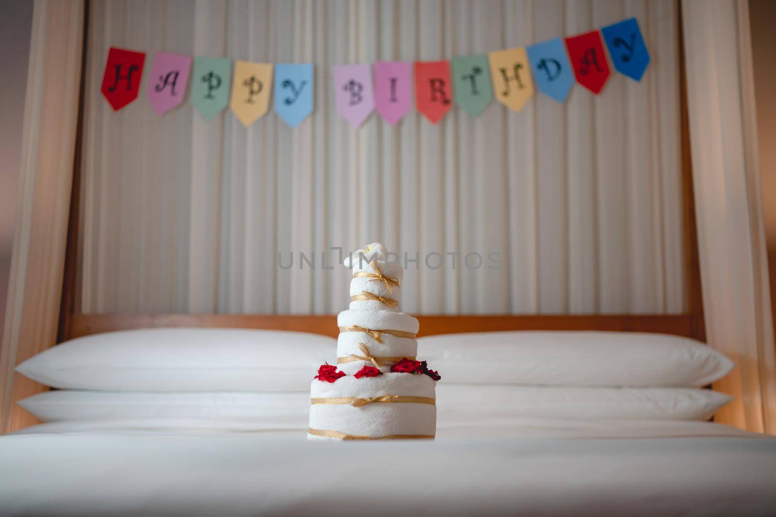 Celebrating Birthday, surprise in bed with Happy birthday banner and towel cake. by sirawit99