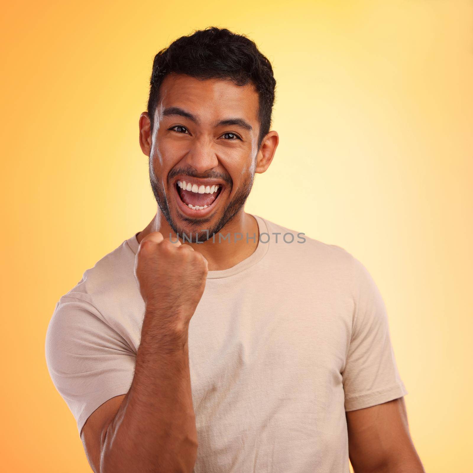 Shot of a young man looking cheerful while standing against a yellow background.
