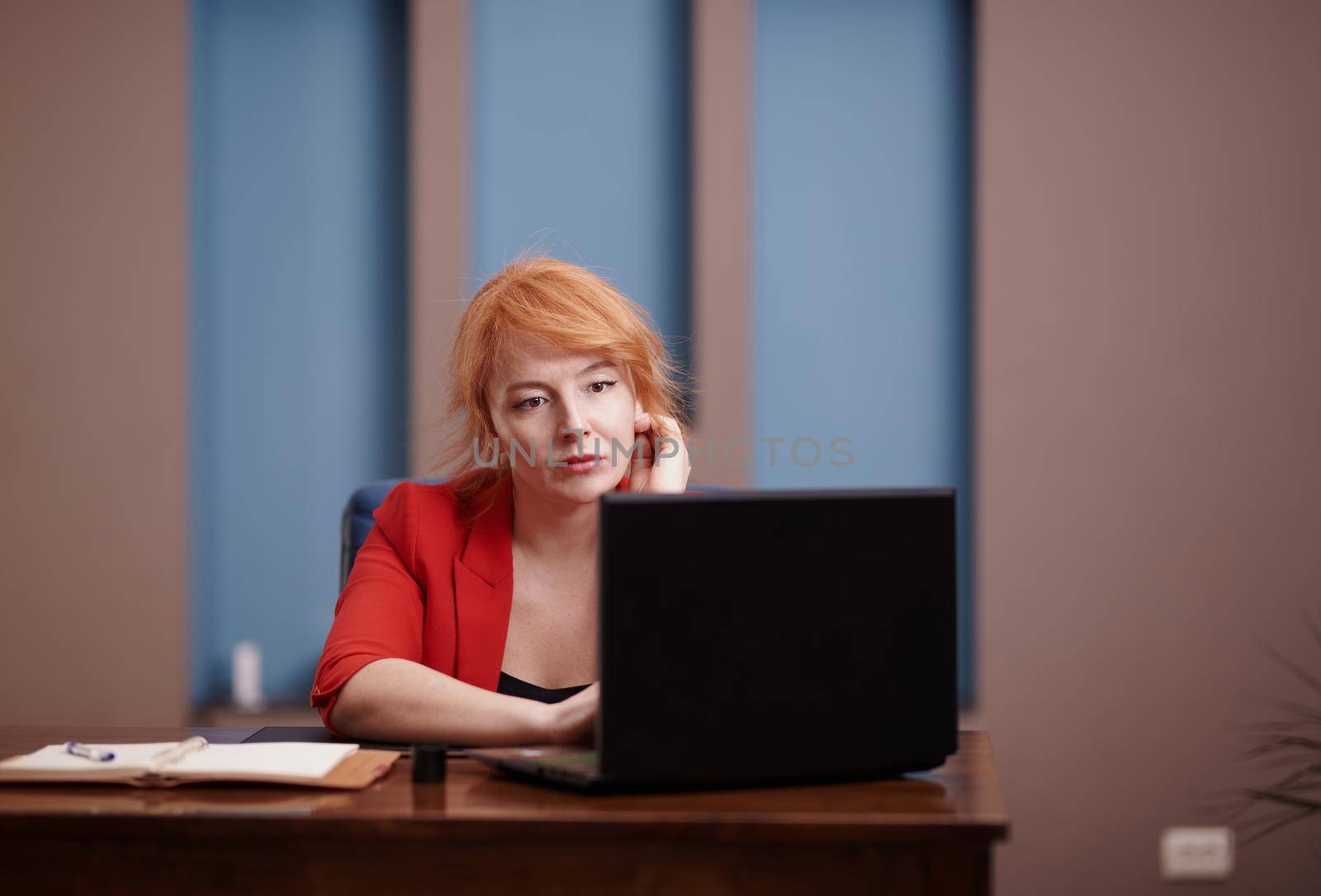 Businesswoman working on laptop at the office by Novic