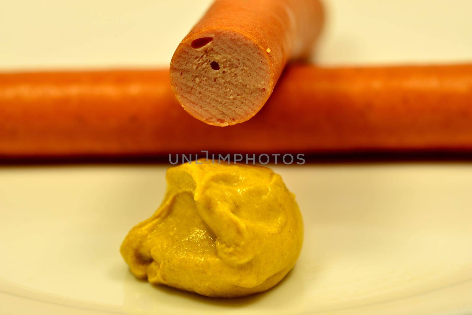 Wiener sausage with mustard in a closeup by Jochen