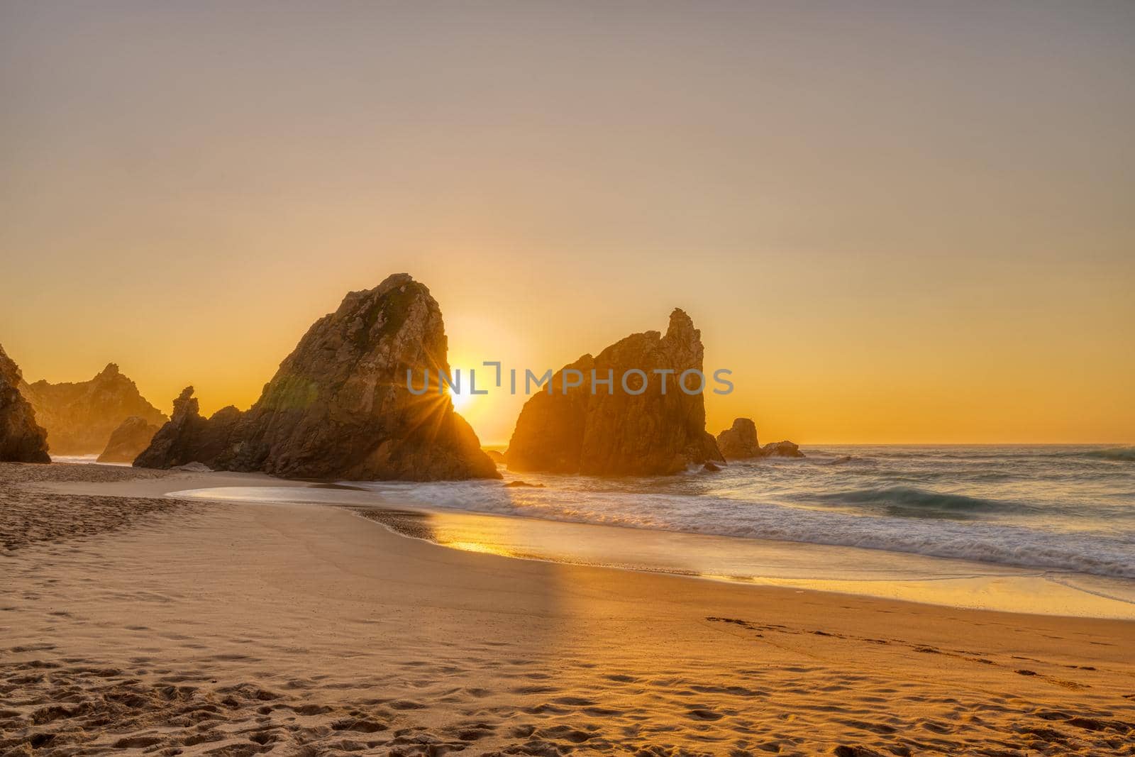 Beautiful sunset on a beach with sea stacks by elxeneize