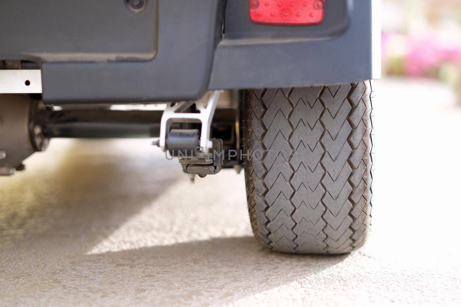 Rubber black car wheel standing on asphalt closeup. Car parking rules concept