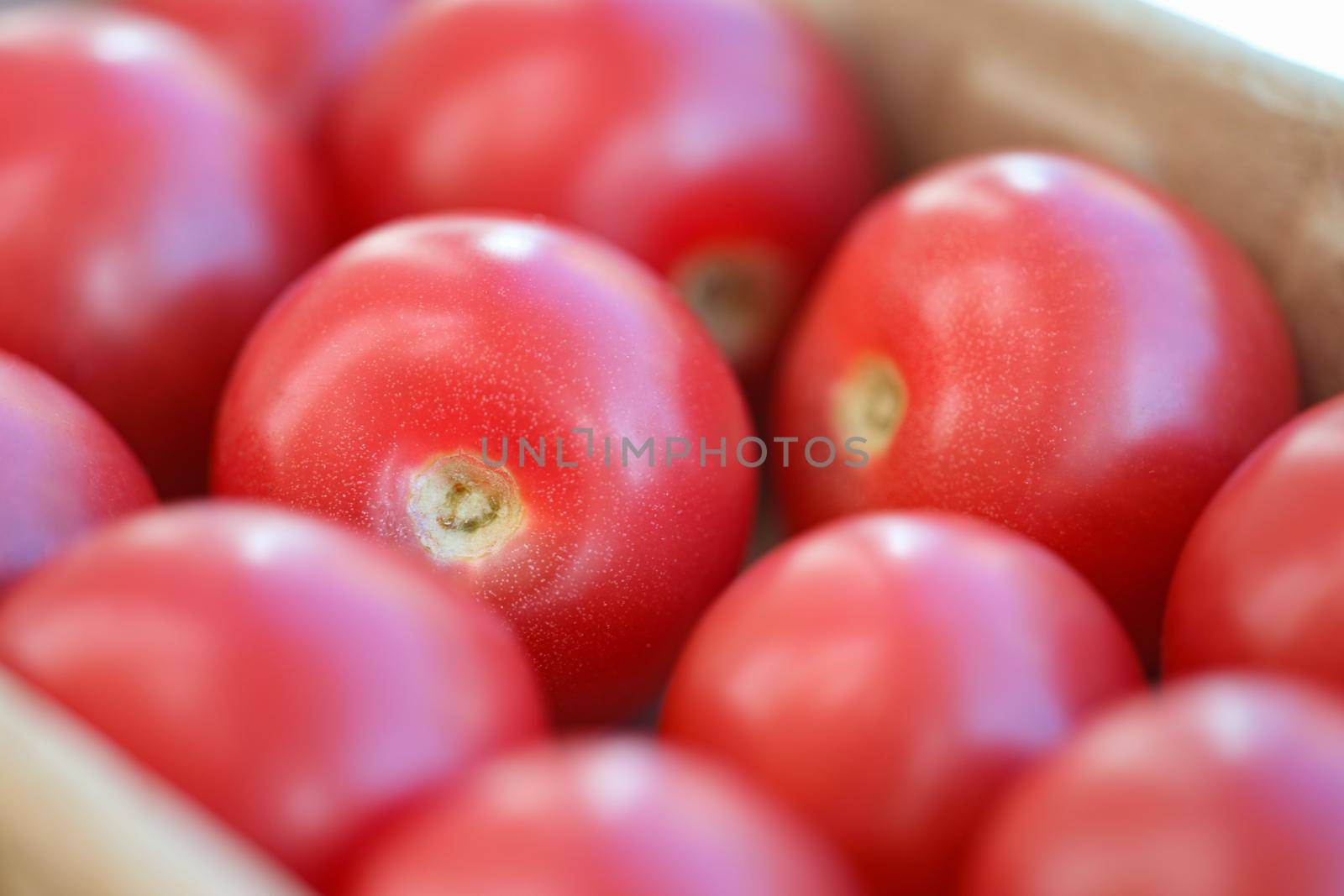 Lot of ripe red tomatoes in shop window background closeup. Healthy food concept