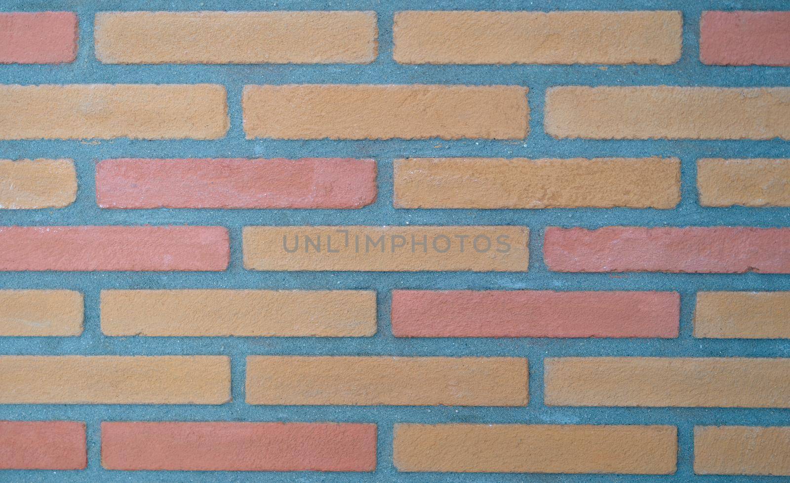 Brown tiles in form of bricks on wall background closeup. Interior design material sale concept