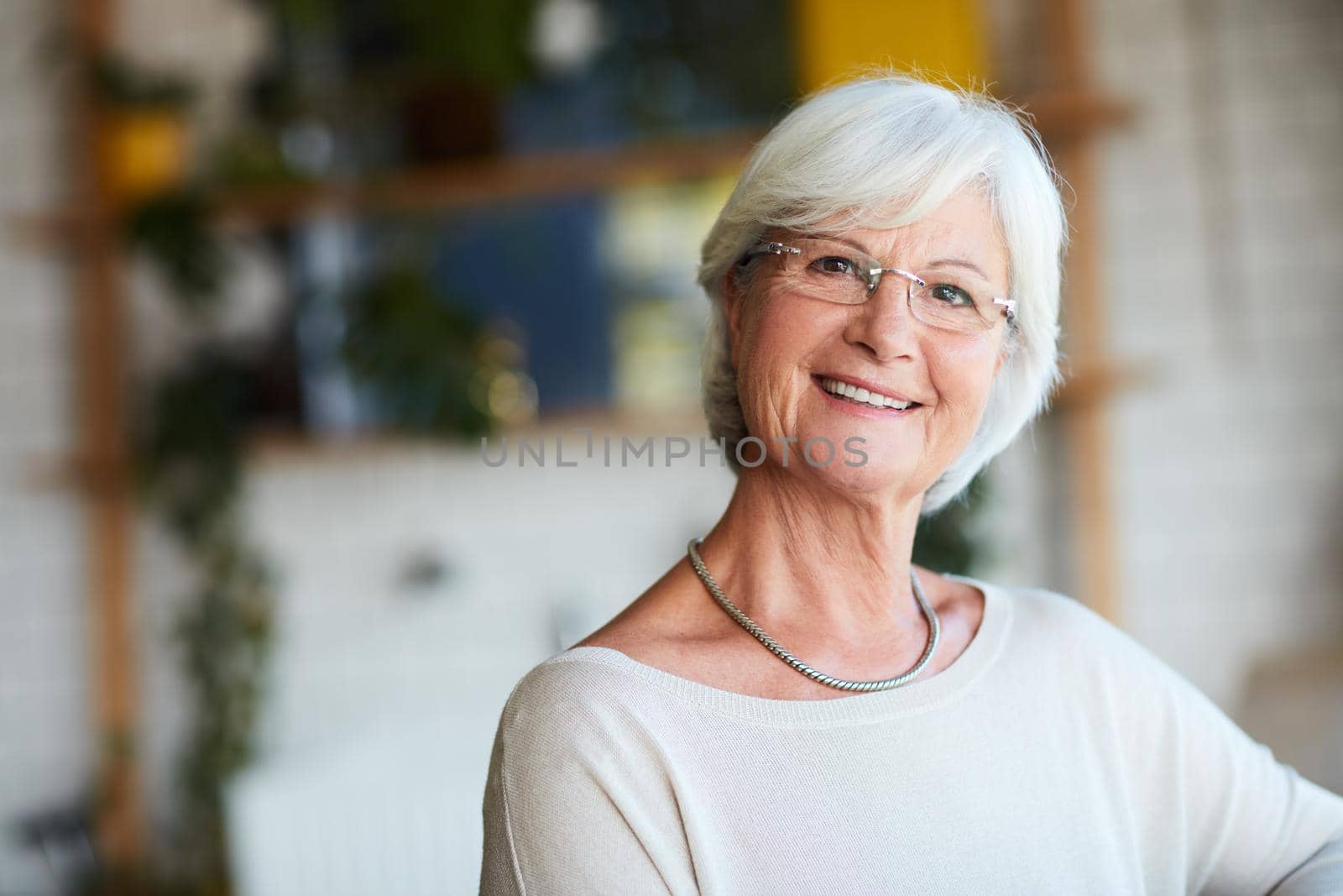Cropped portrait of a senior woman sitting in her local coffee shop.