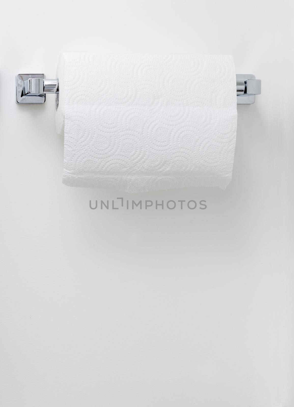 Modern paper towel holder on a white wall background