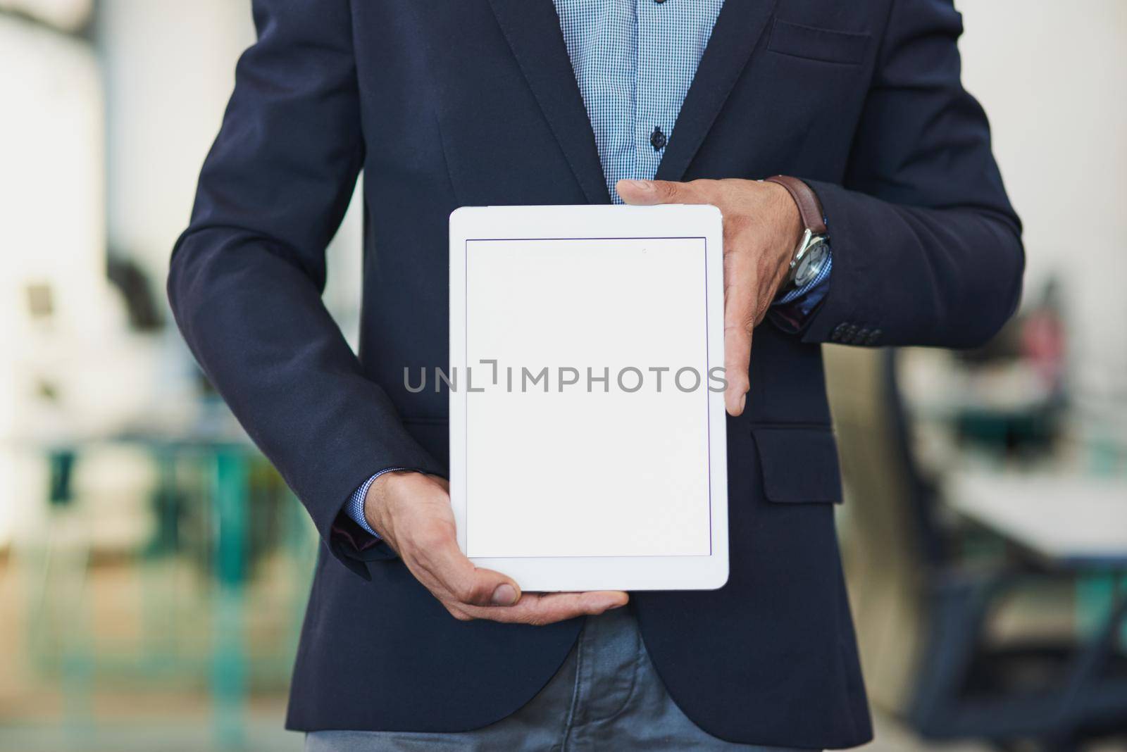 Lets get everyone talking about your business. Closeup shot of an unrecognizable businessman holding up a digital tablet with a blank screen in an office. by YuriArcurs