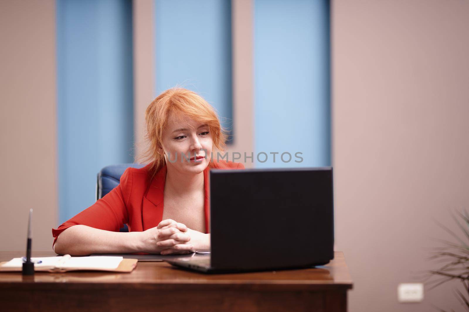 Businesswoman working on laptop at the office by Novic