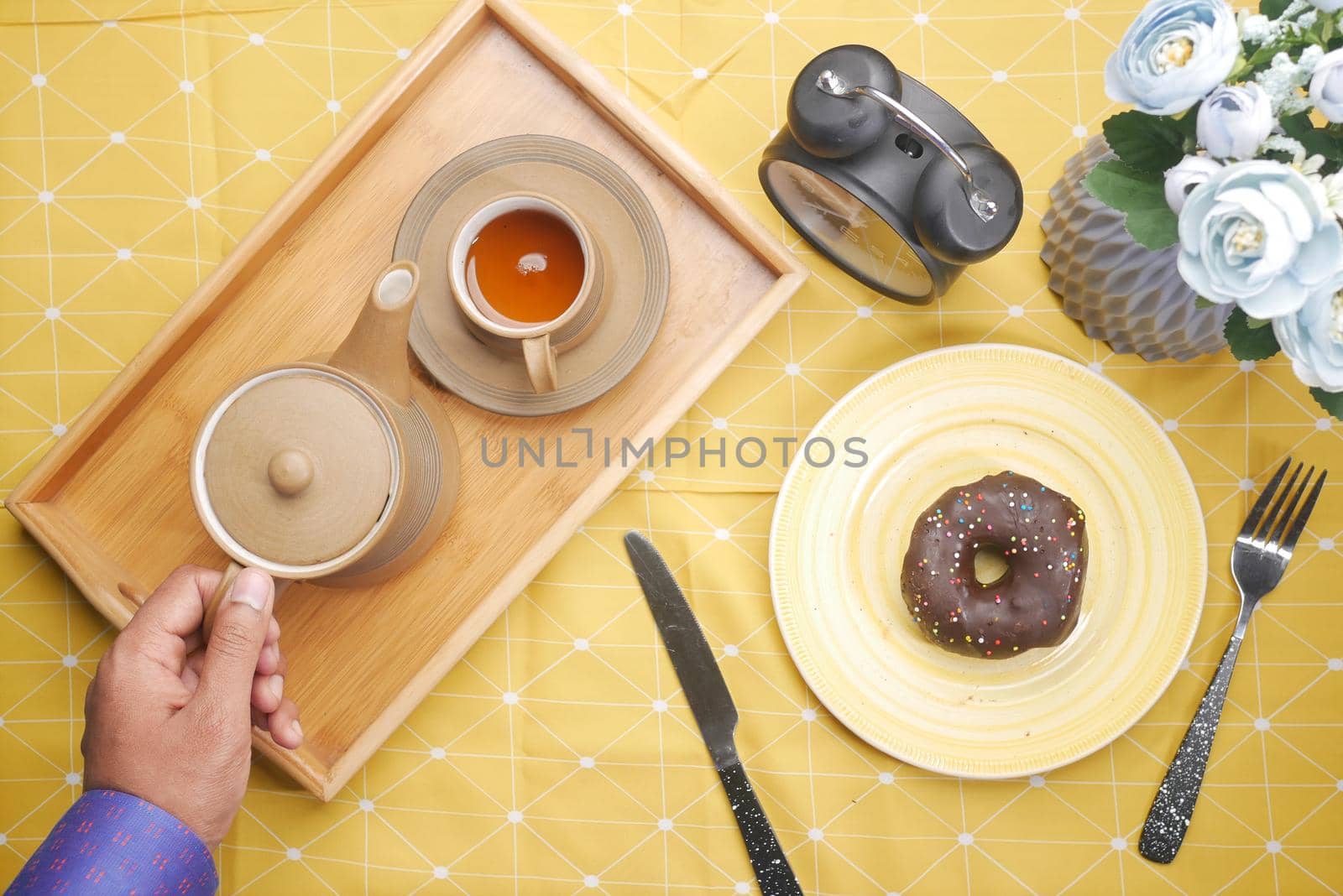 hand holding cup of lemon tea with copy space .