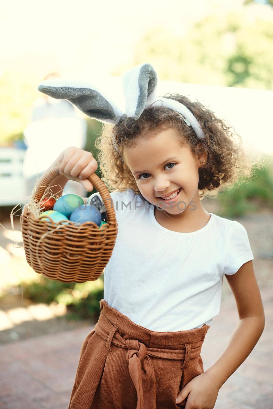Shot of a girl carrying a basket of easter eggs.