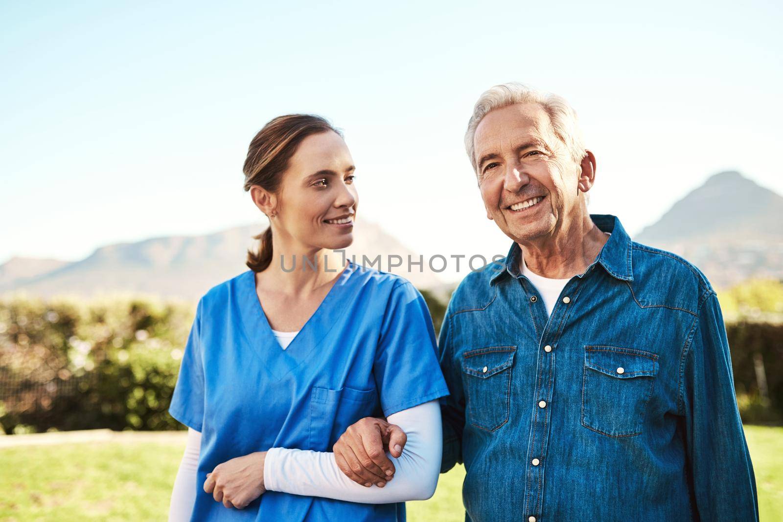 Cropped shot of a young female nurse outside with a senior patient.