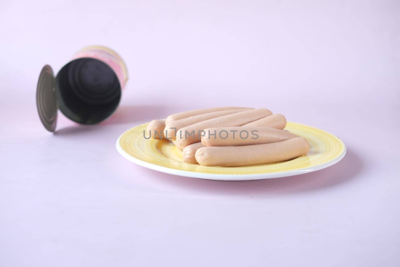 sausage in a tin container on color background .