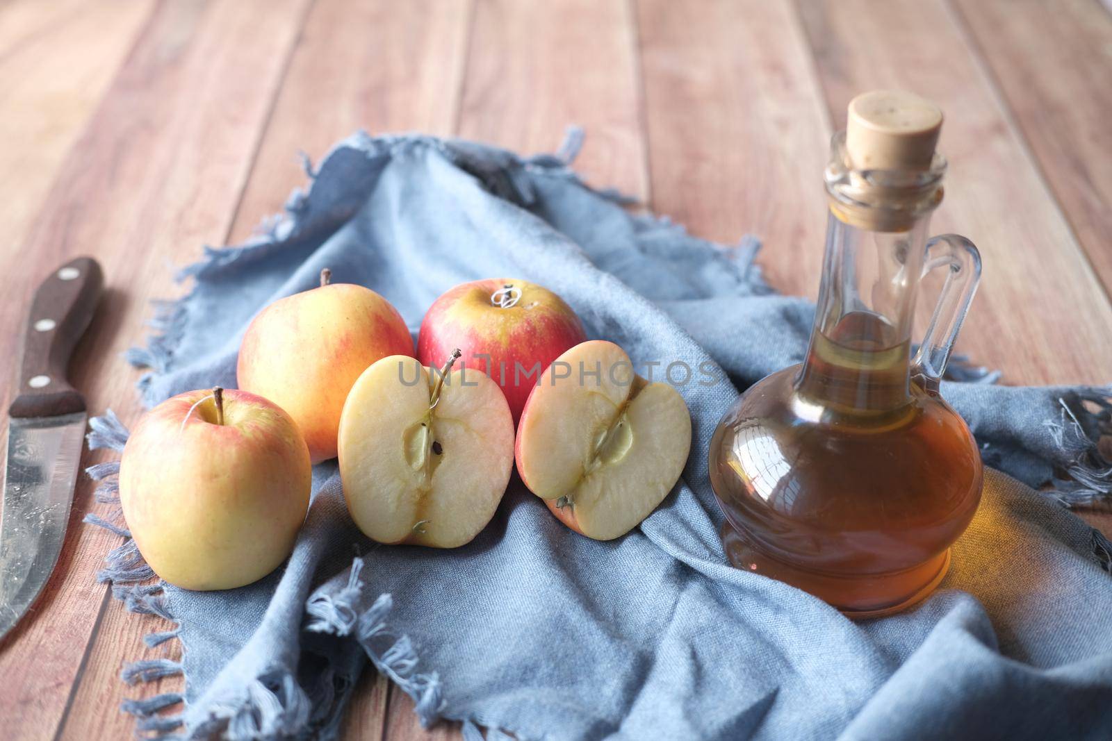 apple vinegar in glass bottle with fresh green apple on table ,