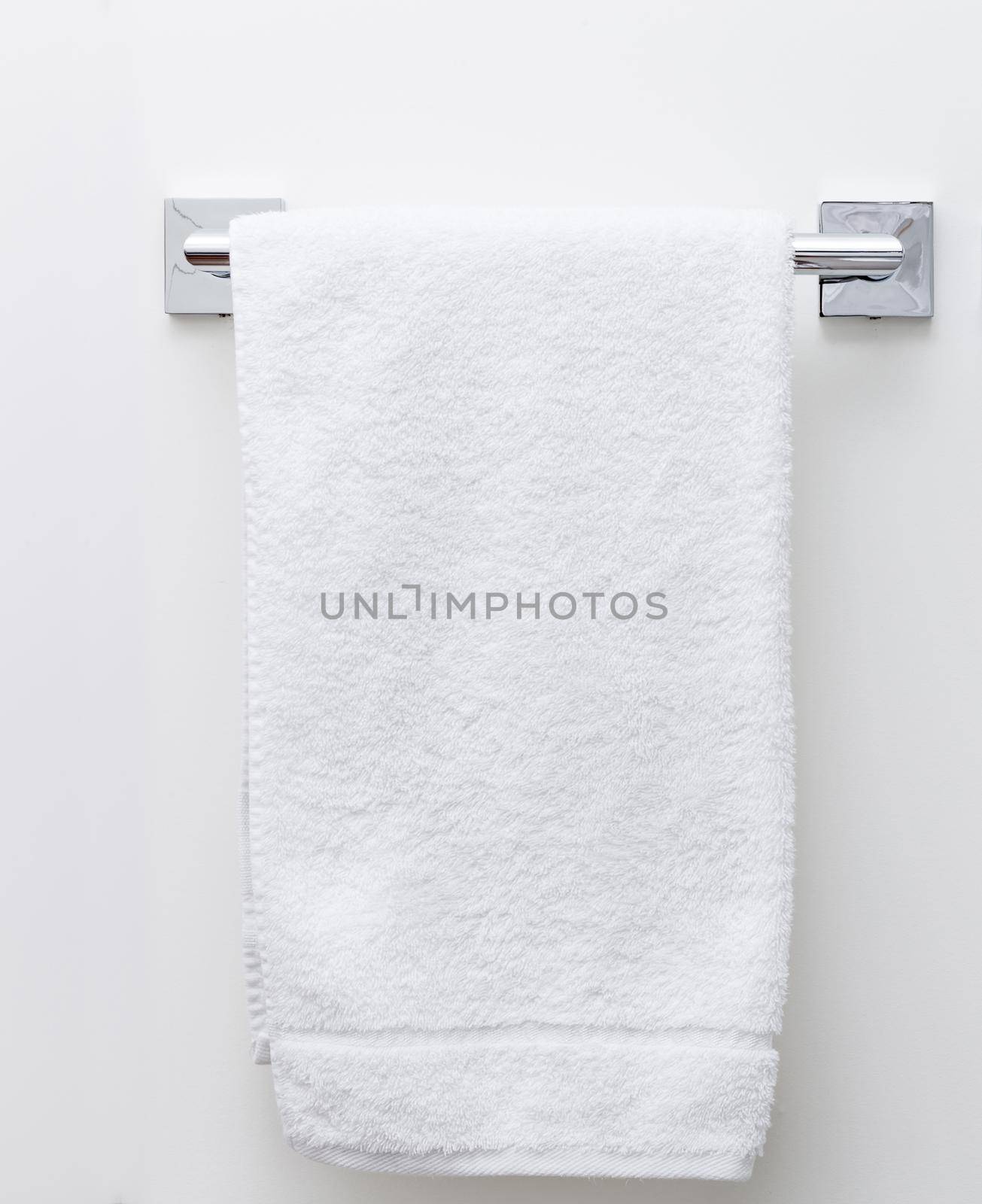 Modern bathroom towel dryer on a white wall background