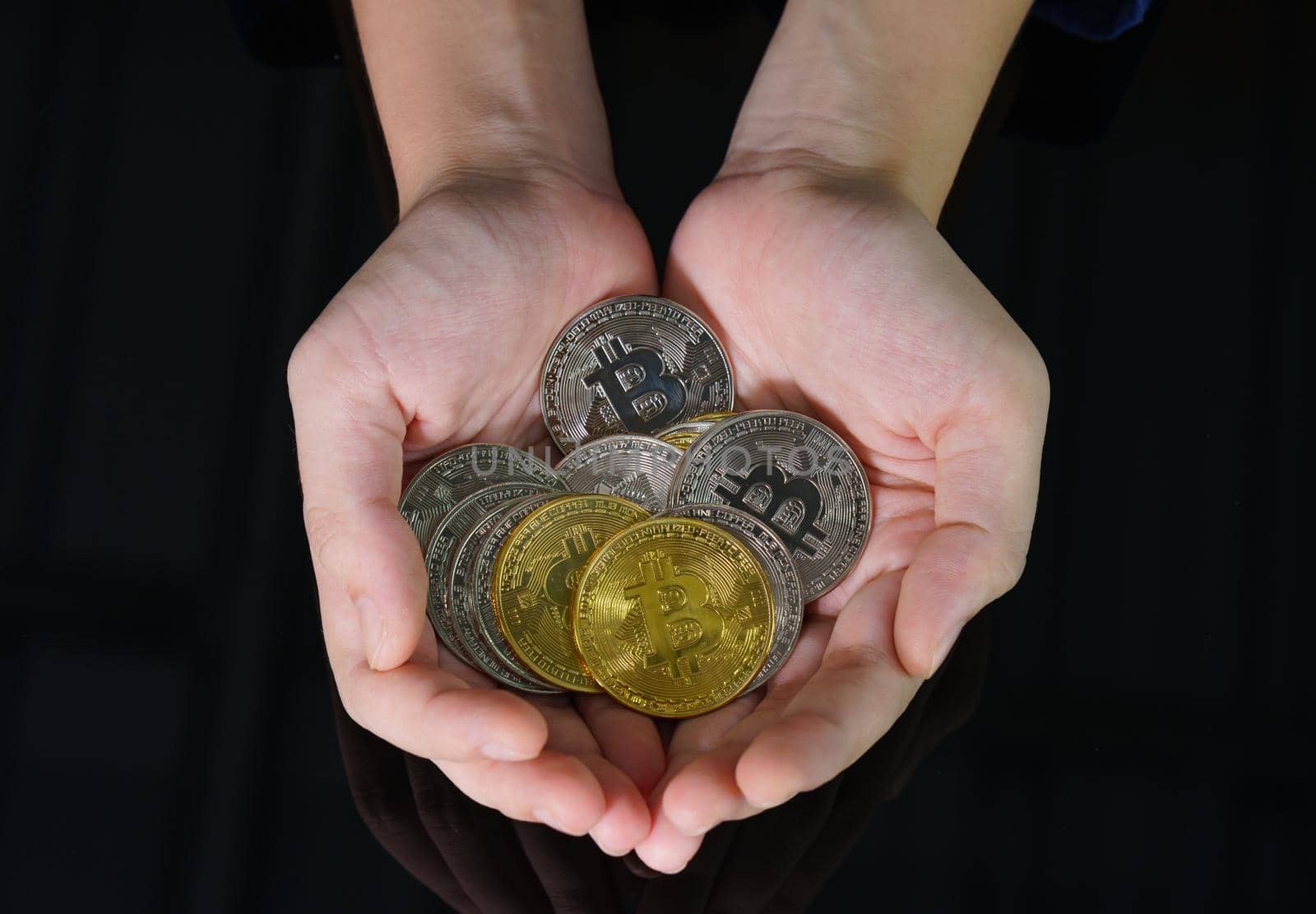 Bitcoin coins in the hand of a  women by stoonn